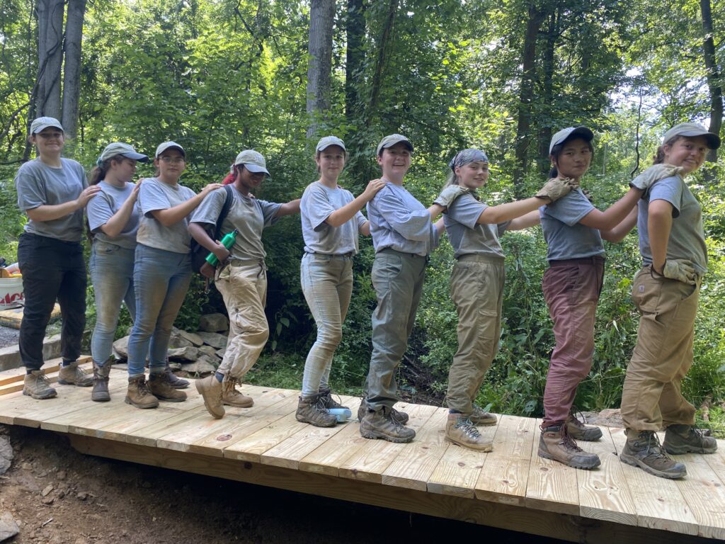 YCC members pose after building a foot bridge