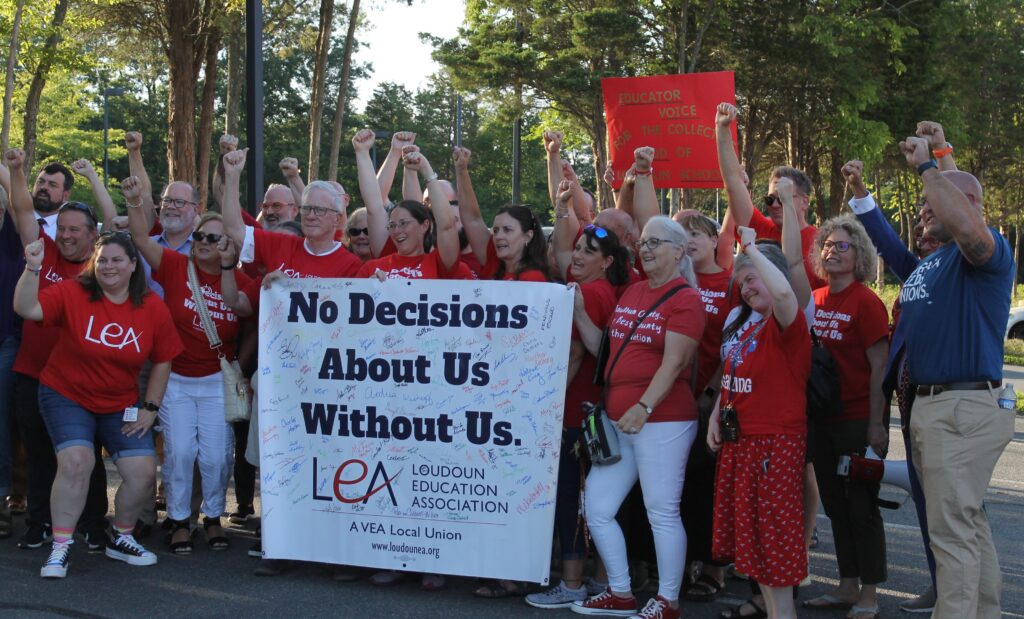 LEA members celebrate outside after the successful vote