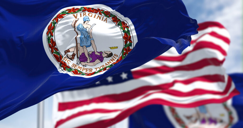 The Virginia state flag waving along with the national flag of the United States of America. Virginia is a state in the Mid-Atlantic and Southeastern regions of the United States